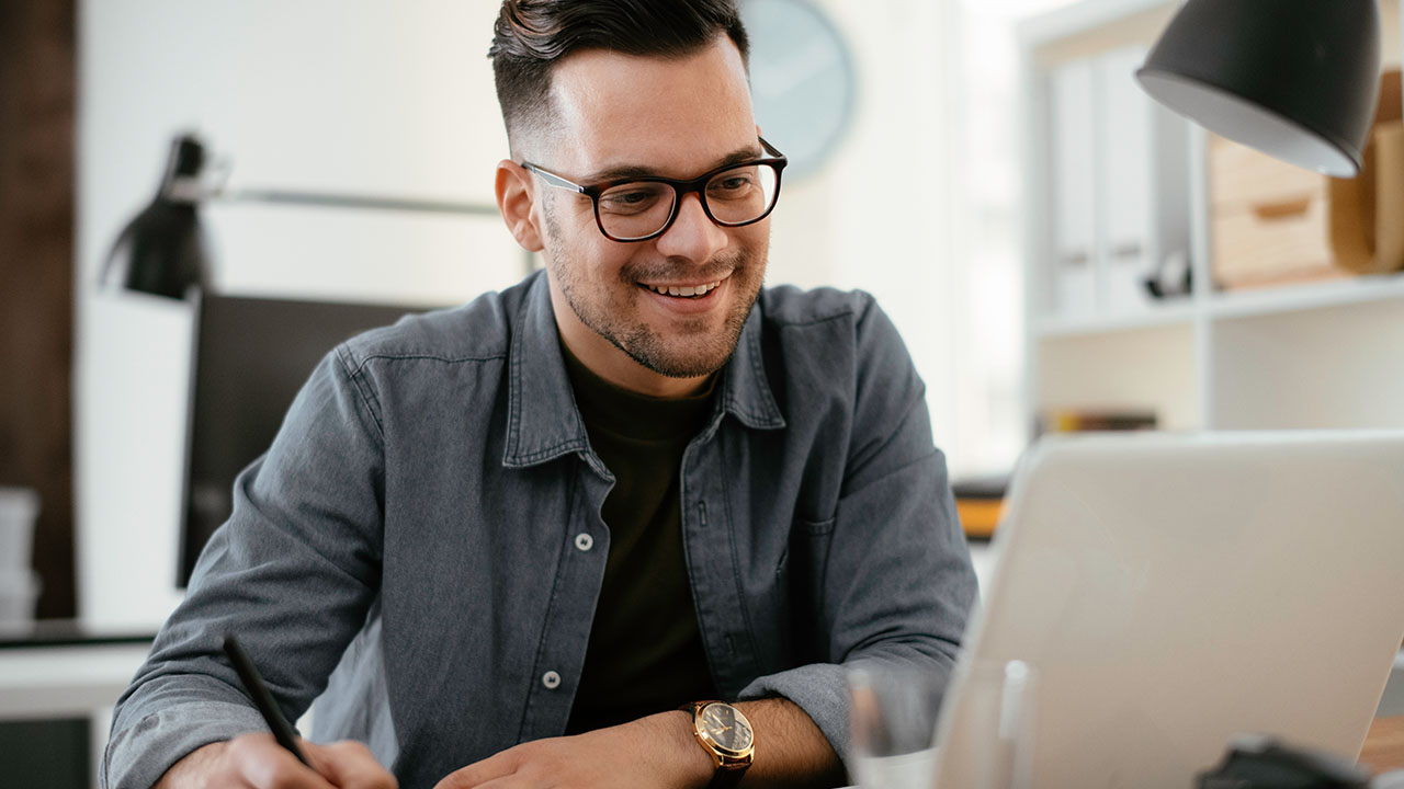 Man wearing glasses at a laptop computer