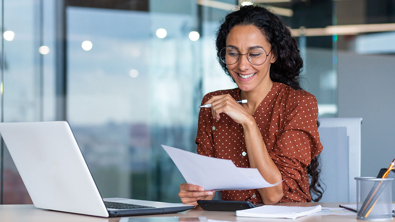 Female in a polkadot shirt working in an office building