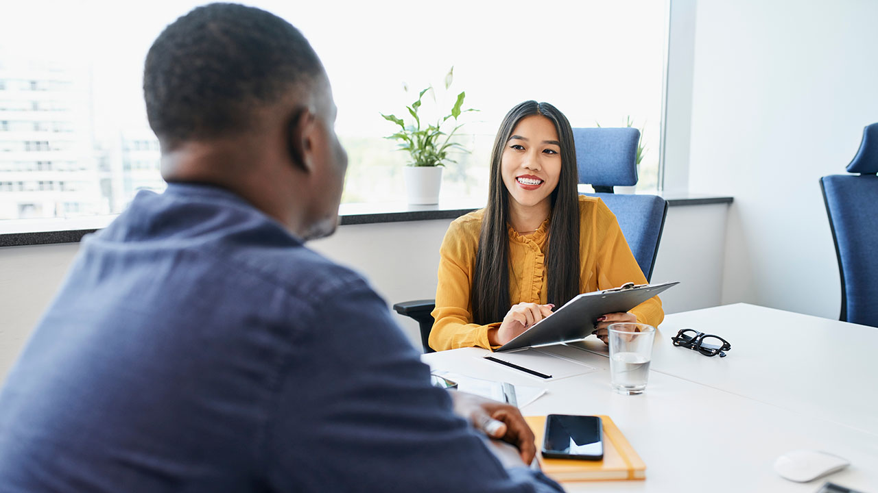 Female holding a clipboard in a professional business setting